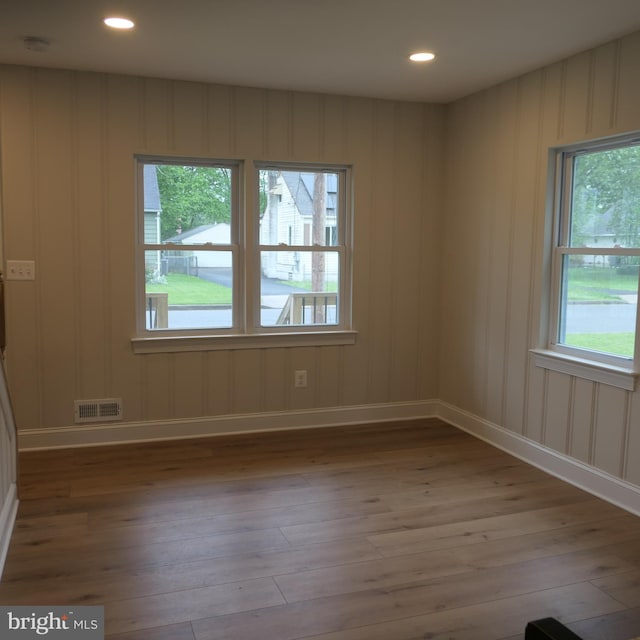 spare room with plenty of natural light and light hardwood / wood-style floors