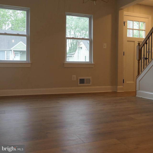 interior space with dark hardwood / wood-style flooring and a wealth of natural light