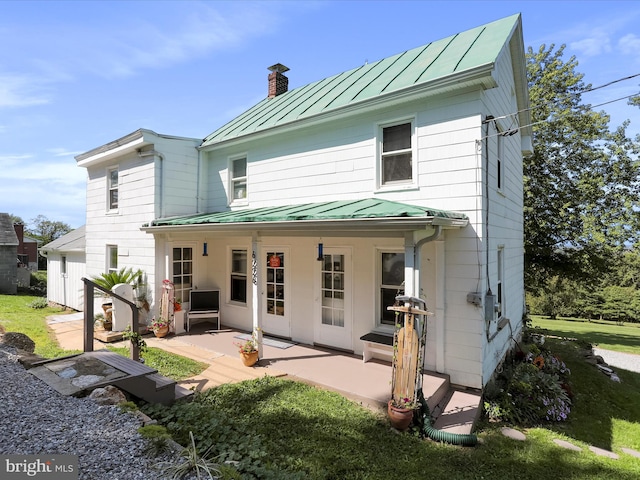 back of property featuring a patio area