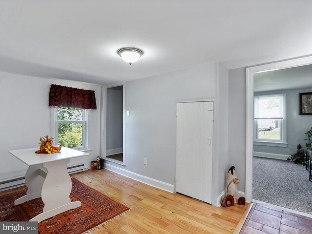 dining room with hardwood / wood-style flooring and baseboard heating