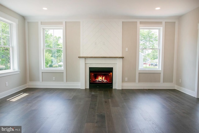 unfurnished living room with dark hardwood / wood-style flooring