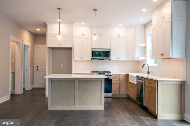 kitchen featuring stainless steel appliances, dark wood-type flooring, decorative light fixtures, white cabinets, and a center island