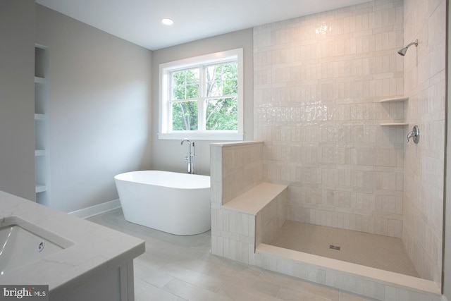 bathroom with tile patterned flooring, built in shelves, vanity, and shower with separate bathtub