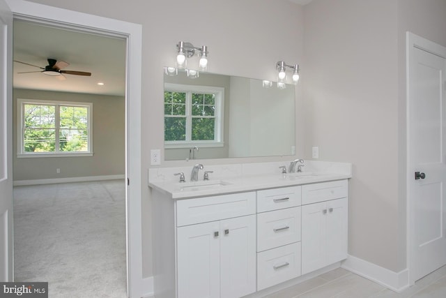 bathroom featuring ceiling fan and vanity