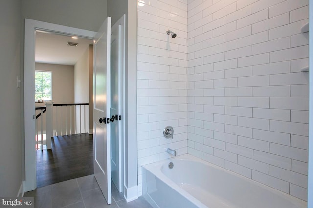 bathroom with tile patterned flooring and tiled shower / bath combo