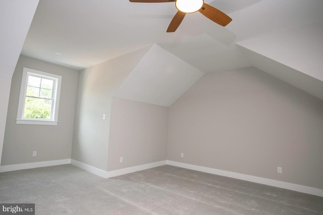 additional living space featuring ceiling fan, light colored carpet, and vaulted ceiling