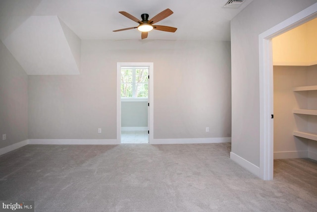 interior space with light carpet and ceiling fan