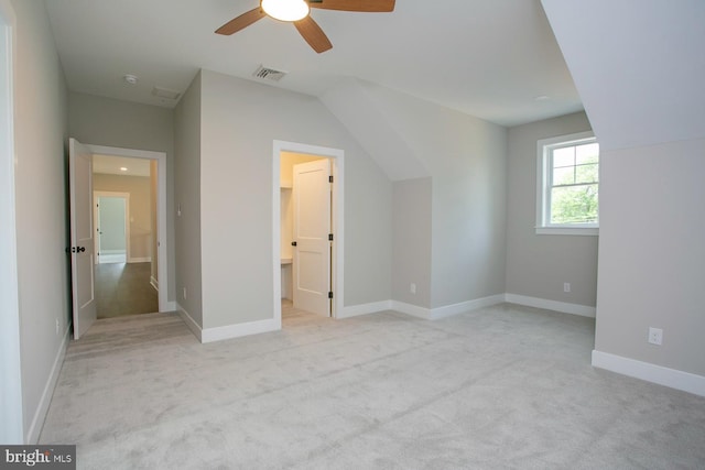 bonus room with light carpet and ceiling fan