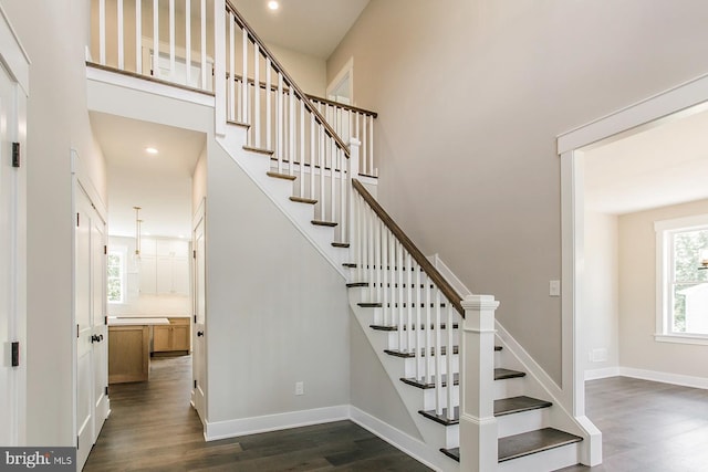 staircase with hardwood / wood-style flooring