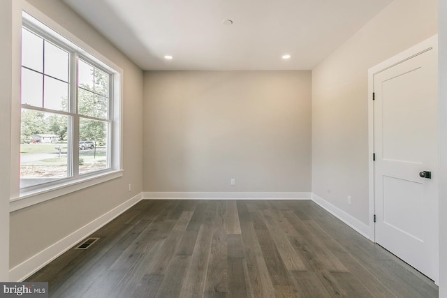 unfurnished room featuring dark wood-type flooring