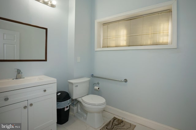 bathroom with tile flooring, oversized vanity, and toilet