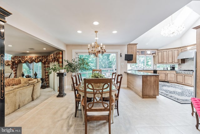 tiled dining area with a notable chandelier, plenty of natural light, sink, and vaulted ceiling