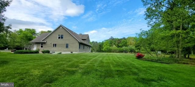 view of side of property with a lawn