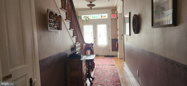 interior space with crown molding and french doors