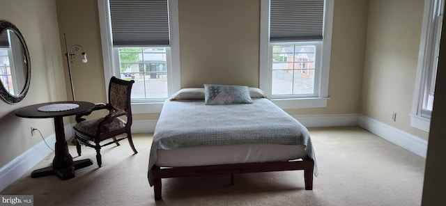 bedroom with light colored carpet