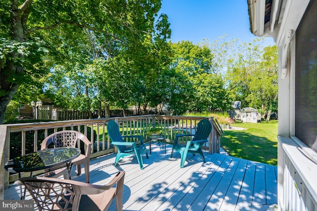 deck with a lawn and a storage shed