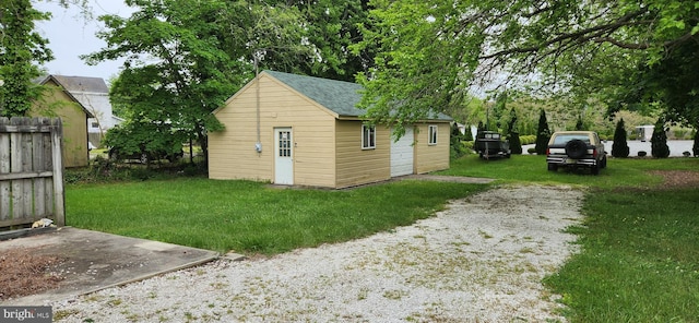 view of outbuilding with a yard