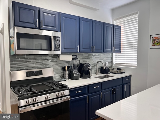 kitchen featuring plenty of natural light, appliances with stainless steel finishes, and blue cabinets