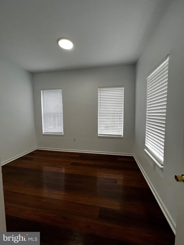 empty room with dark wood-type flooring