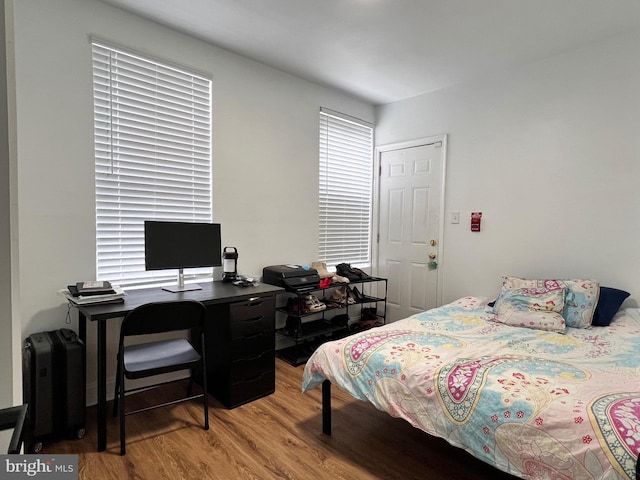 bedroom with wood-type flooring