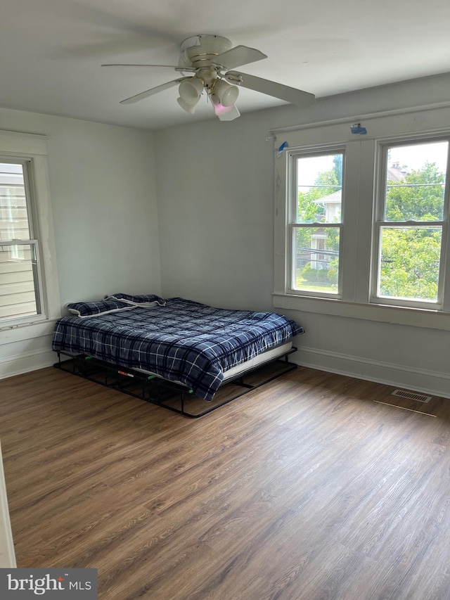 bedroom featuring ceiling fan and dark wood-type flooring