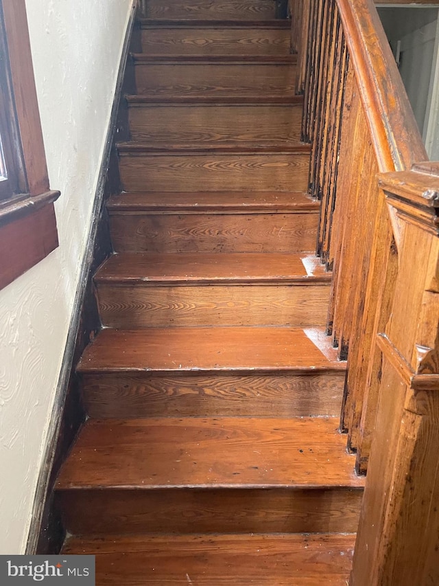 stairway featuring hardwood / wood-style flooring