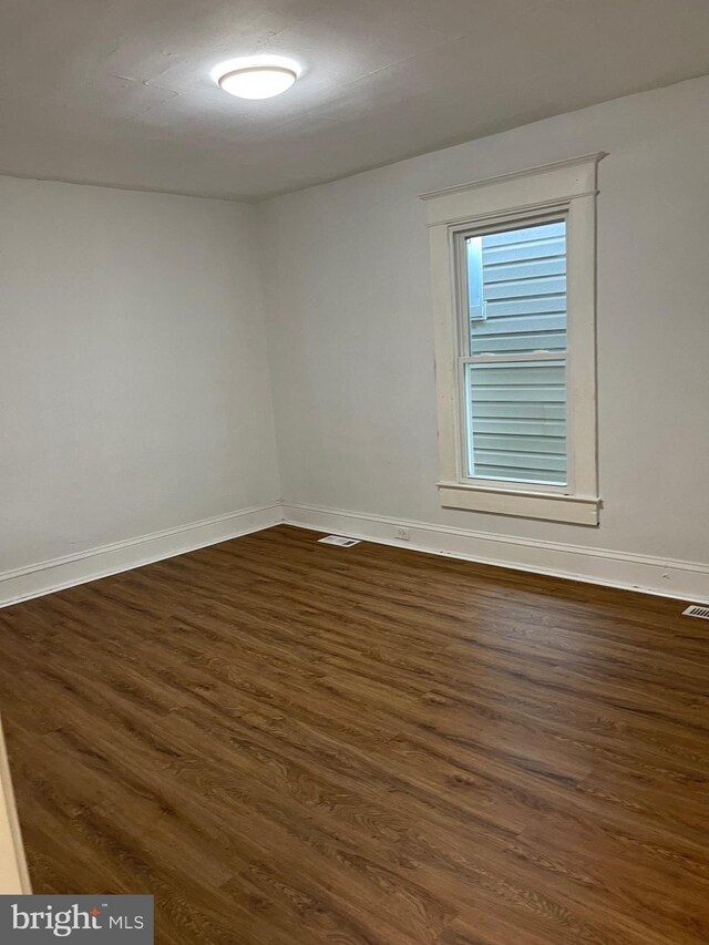 spare room featuring dark hardwood / wood-style floors