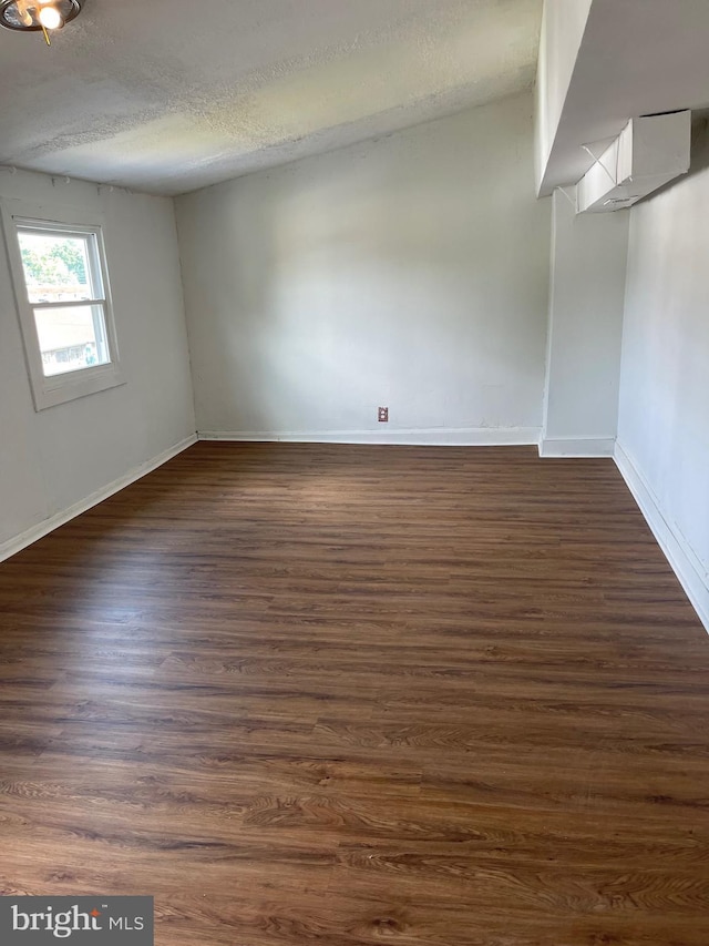 interior space featuring dark hardwood / wood-style flooring and a textured ceiling