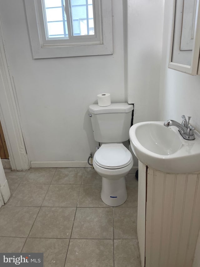 bathroom featuring tile patterned floors, vanity, and toilet