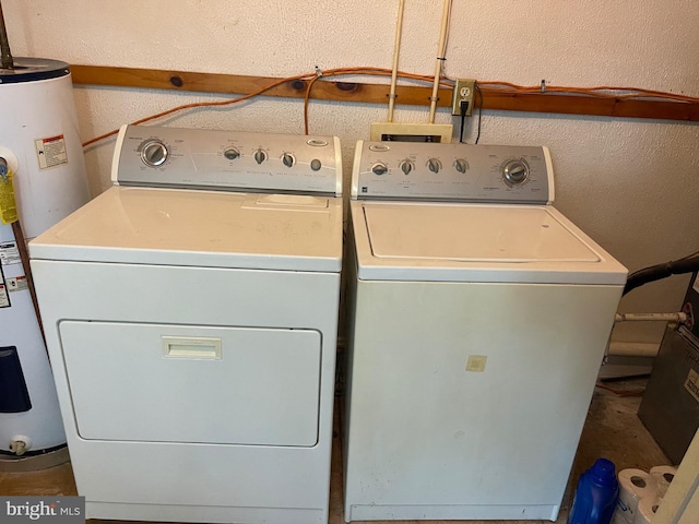 washroom featuring water heater and washer and dryer