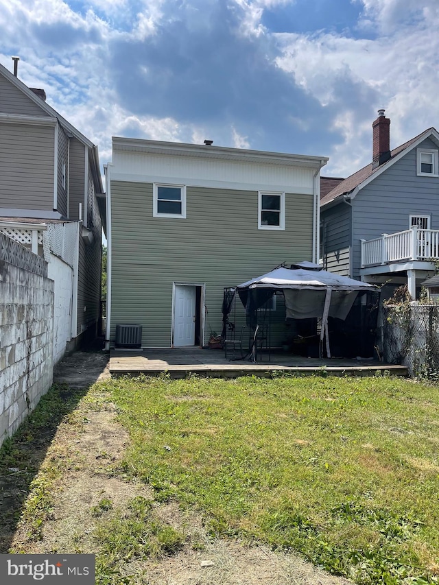 rear view of house featuring a lawn