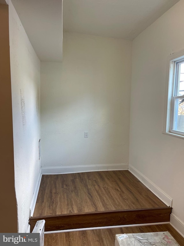 spare room with dark hardwood / wood-style floors