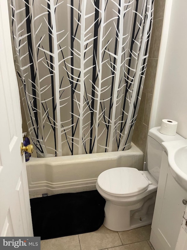 full bathroom featuring toilet, vanity, tile patterned floors, and shower / bath combo with shower curtain