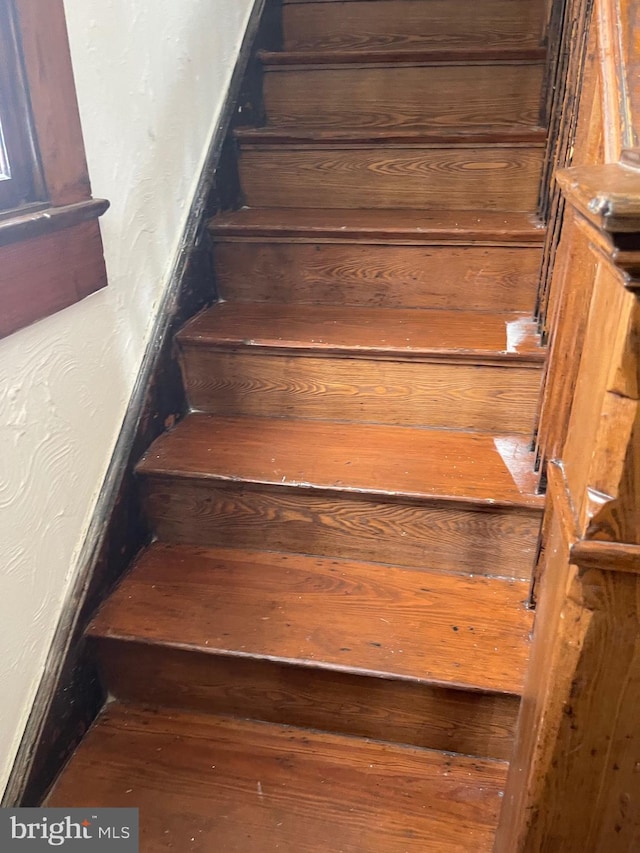 stairway with hardwood / wood-style flooring