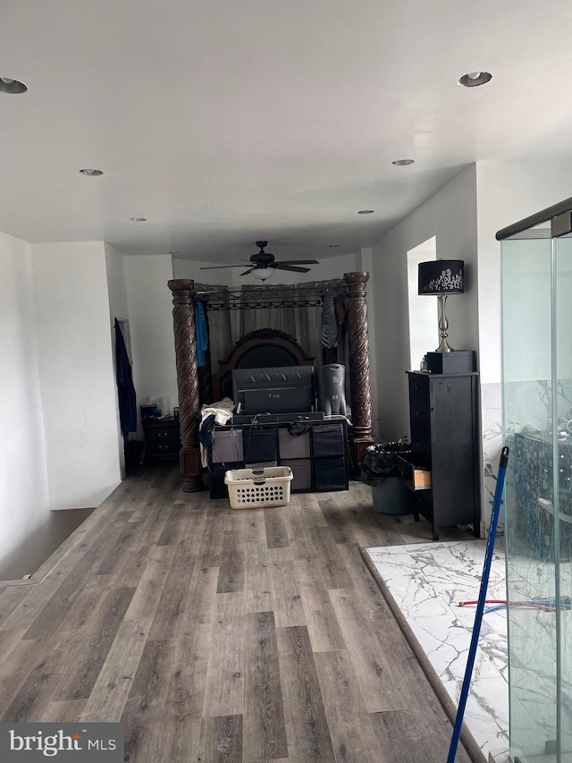 interior space featuring wood-type flooring and ceiling fan