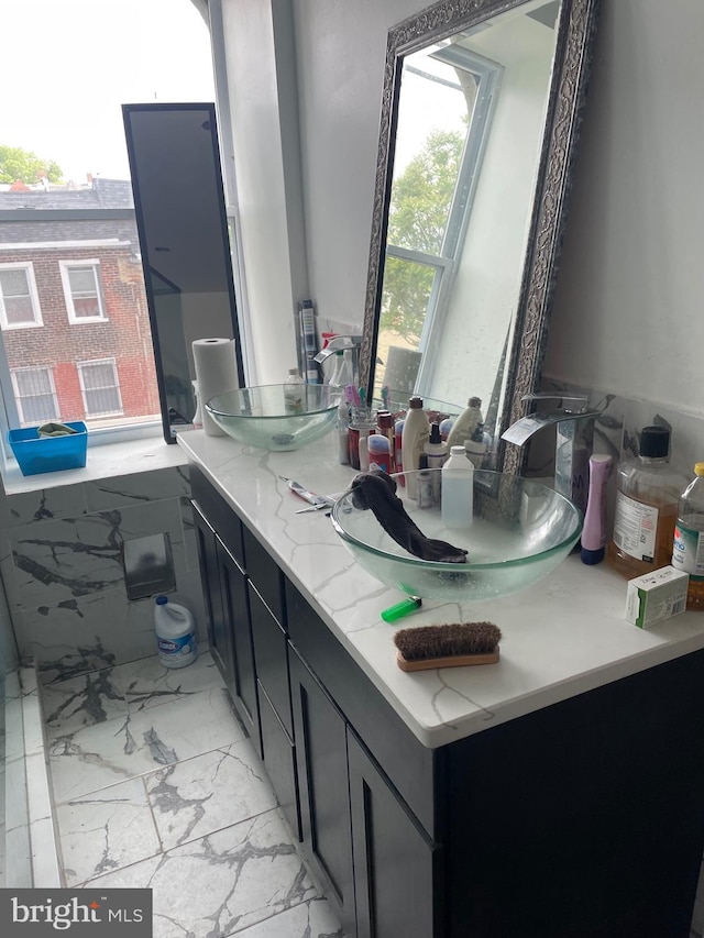 bathroom with double sink, oversized vanity, and tile flooring