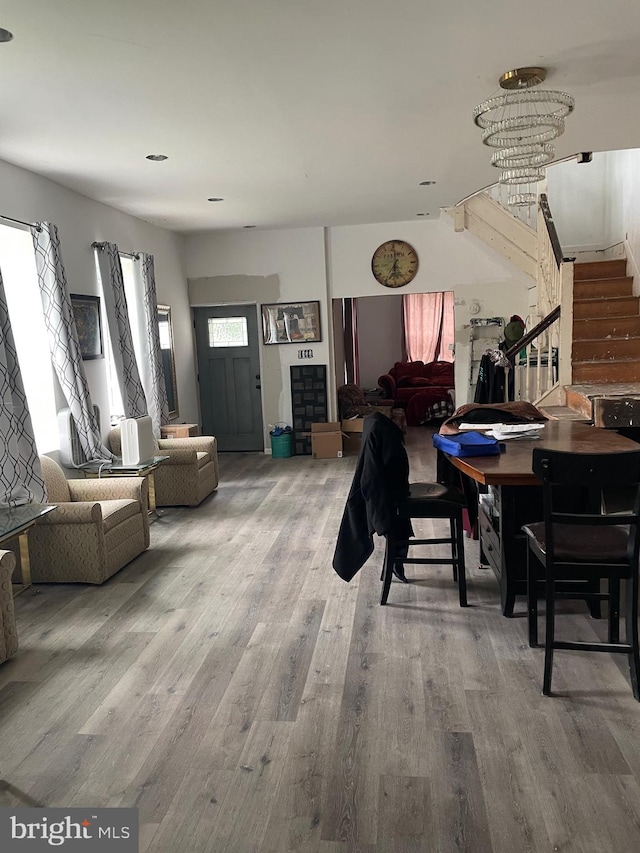 dining area featuring hardwood / wood-style floors and an inviting chandelier