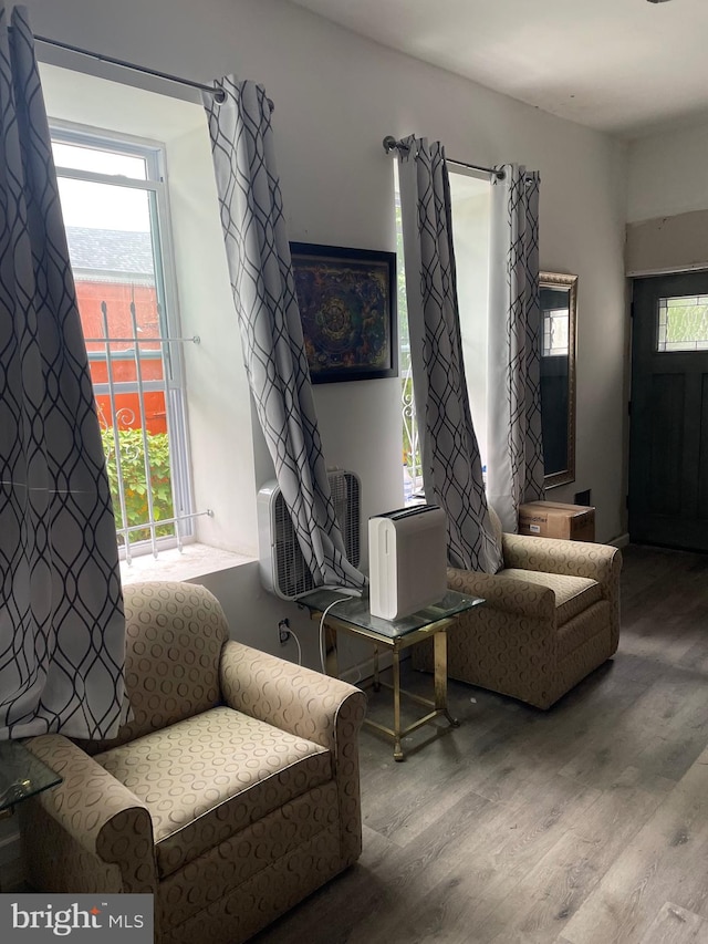 living room with plenty of natural light and hardwood / wood-style flooring