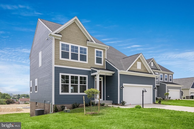 craftsman-style home featuring a garage, central AC unit, and a front lawn