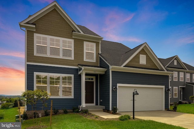 craftsman-style home with a yard and a garage