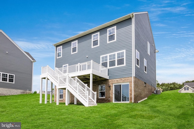 back of house with a deck, a yard, and central AC