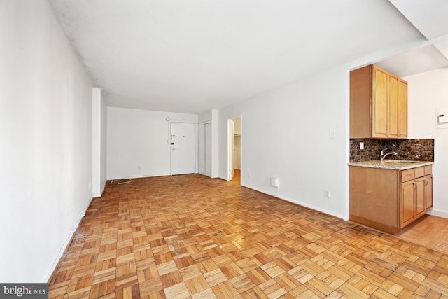 unfurnished living room featuring sink and light parquet flooring