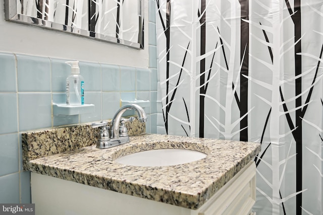 bathroom with tile walls, backsplash, and vanity