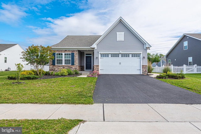 view of front of property featuring a garage and a front yard