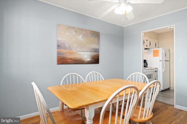 dining area featuring a textured ceiling, ceiling fan, and hardwood / wood-style floors