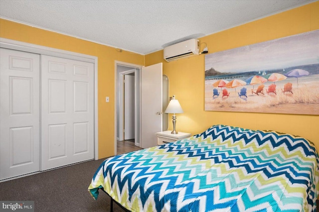 bedroom featuring dark carpet, a closet, a textured ceiling, and an AC wall unit