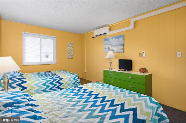 carpeted bedroom with a textured ceiling and a wall mounted air conditioner