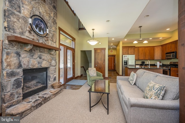 tiled living room with a stone fireplace and sink