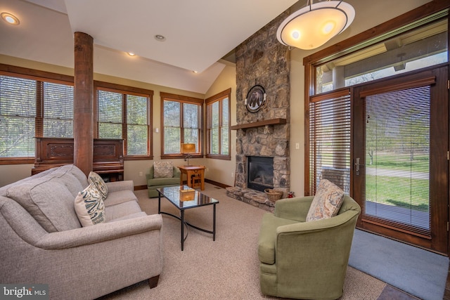 living room with plenty of natural light, a fireplace, carpet, and lofted ceiling