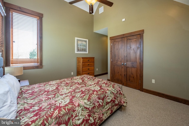 bedroom featuring carpet flooring, ceiling fan, high vaulted ceiling, and a closet